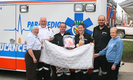 Bervie W.I. presents quilt-bear packages to local paramedics